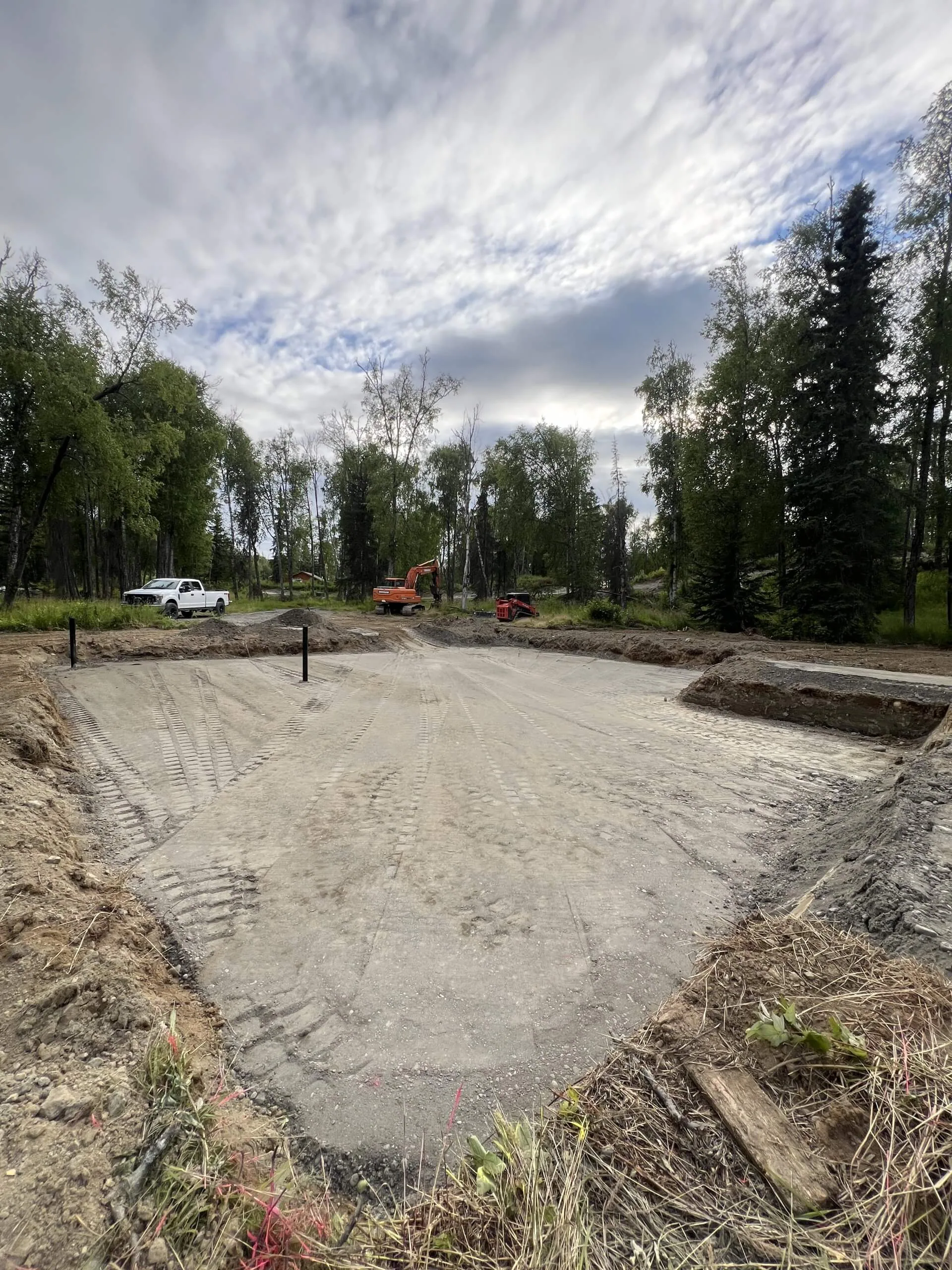 Graded building pad tire tread marks orange excavator lake city site prep